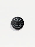 Black cosmetic jar lid of Hyaluronic Radiance Cream on neutral background